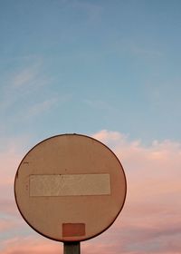 Low angle view of road sign against sky