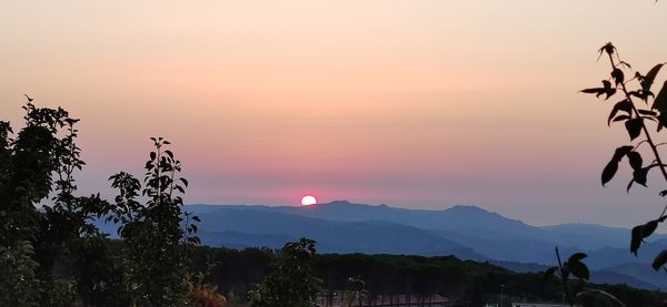 Scenic view of silhouette mountains against sky at sunset