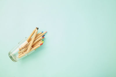 High angle view of pencils on table against white background
