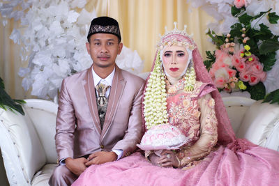 Portrait of young couple during wedding ceremony