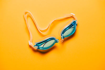 High angle view of paper with swimming goggles on table