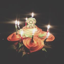 Lit tea light candles in darkroom