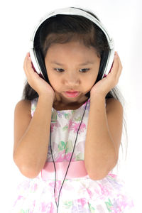 Portrait of cute girl against white background