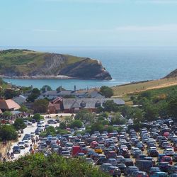 High angle view of townscape by sea against sky