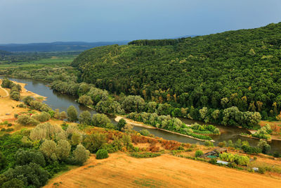 Scenic view of river by landscape against clear sky