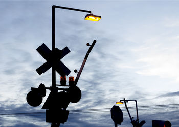 Low angle view of stoplight against sky