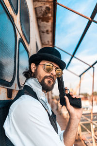 Portrait of young man holding camera