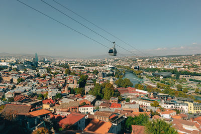 Cityscape view from mountain of tbilisi old town with cable car on the sky in georgia.