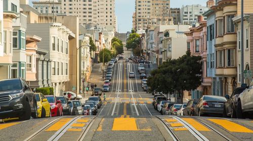 Cars parked at tramway in city