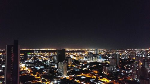 High angle view of illuminated cityscape against sky at night