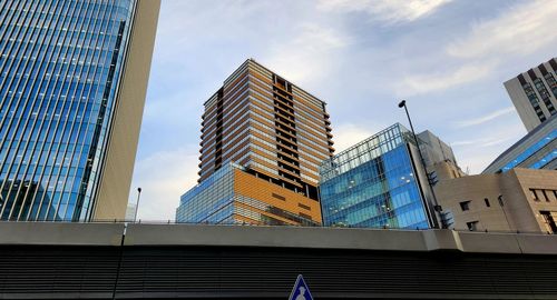Low angle view of modern buildings against sky