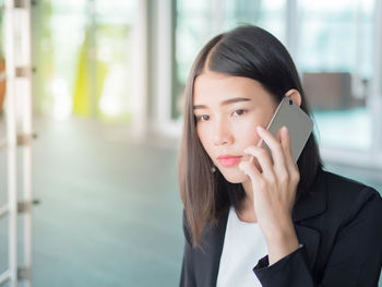 Portrait of a young woman holding smart phone