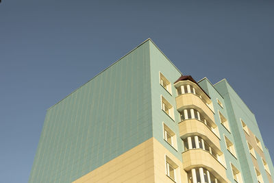 Low angle view of building against clear blue sky