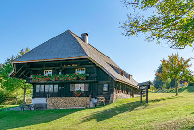 Building on field against clear sky