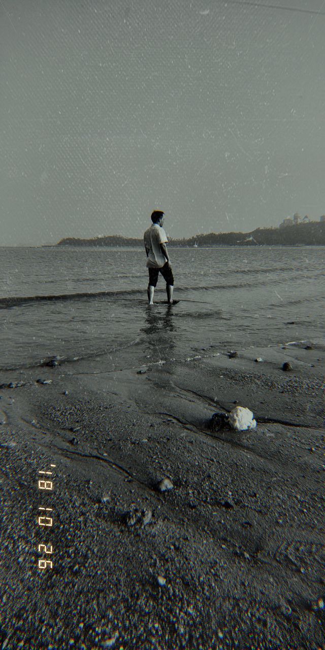 water, full length, real people, one person, land, beach, nature, men, leisure activity, child, standing, day, lifestyles, sea, childhood, males, sky, boys