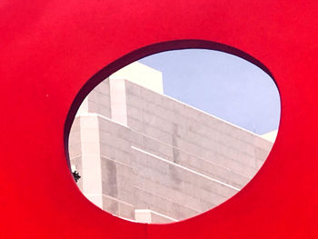 Close-up of sign against red wall