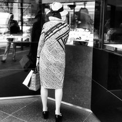 Rear view of woman standing in bus