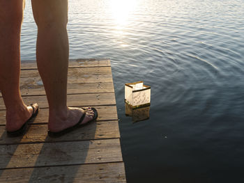 Low section of man standing on jetty