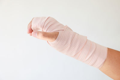 Close-up of man hand against white background