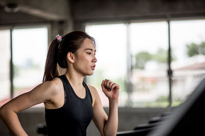 Young woman jogging in gym