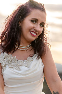 Close-up portrait of beautiful young woman in white