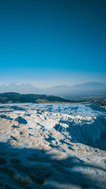 Scenic view of snowcapped mountain against blue sky