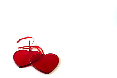 Close-up of red heart shape over white background