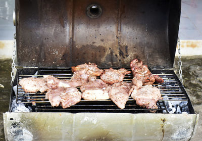 High angle view of meat on barbecue grill