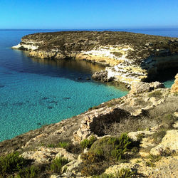 Scenic view of sea against clear blue sky