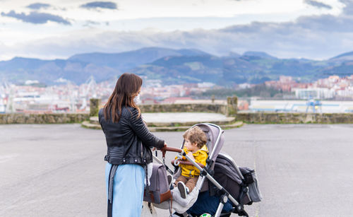 Woman with son on mountain in city