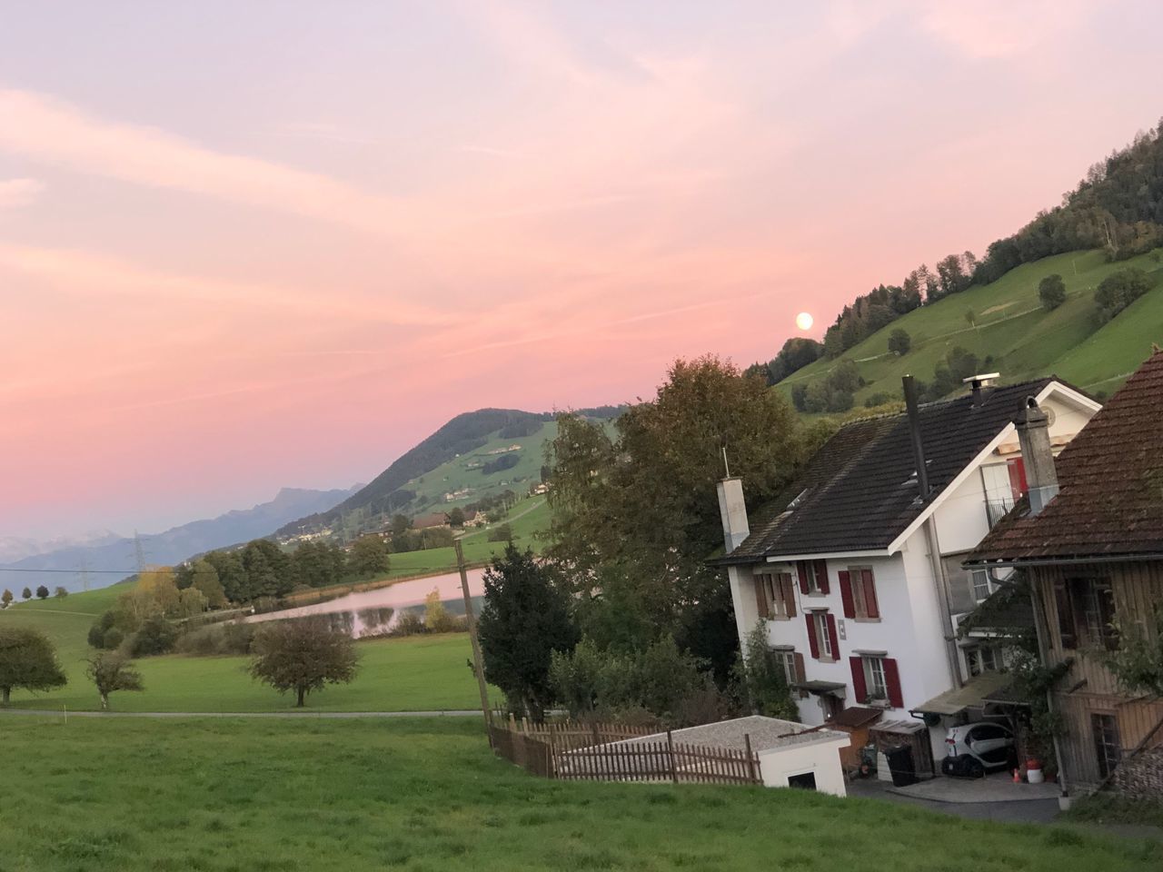 HOUSES ON FIELD AGAINST SKY