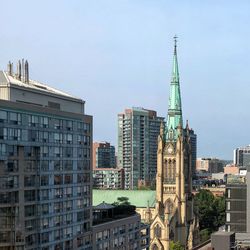 Buildings in city against sky