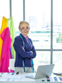 Portrait of woman using mobile phone on table