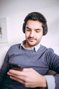 Close-up of young man using mobile phone