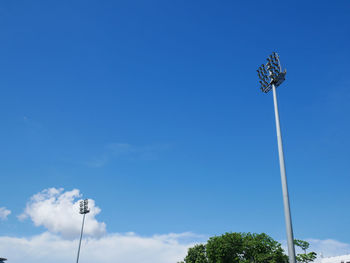 Low angle view of floodlight against blue sky