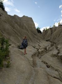 Rear view of woman walking on mountain