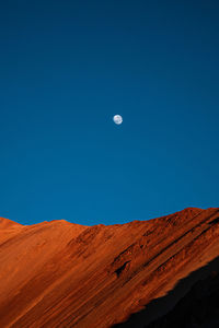 Scenic view of desert against clear blue sky