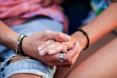 Midsection of couple holding hands