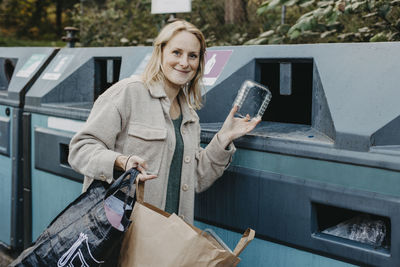 Woman recycling rubbish