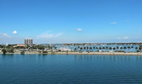 City by sea against blue sky