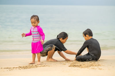 Boys and girls playing at beach