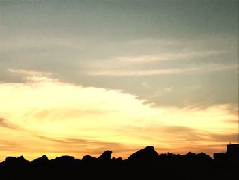 Silhouette of trees against dramatic sky