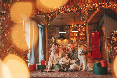 Candid authentic happy family during wintertime together enjoying holidays with dog at xmas