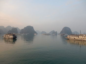 Boats in sea against sky