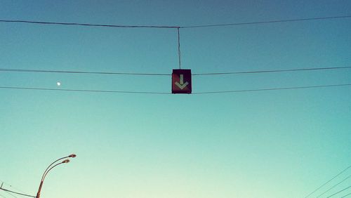 Low angle view of power lines against blue sky