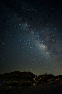 Scenic view of mountains against star field at night