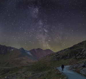 Scenic view of mountains against sky at night