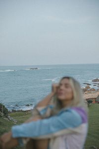 Portrait of woman sitting at beach