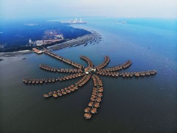 Aerial view of stilt houses over sea at beach