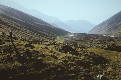 Person standing in a valley